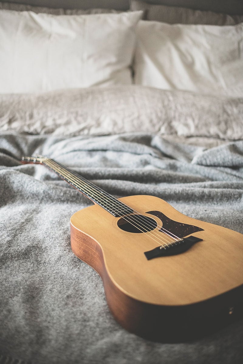 Guitar on bed